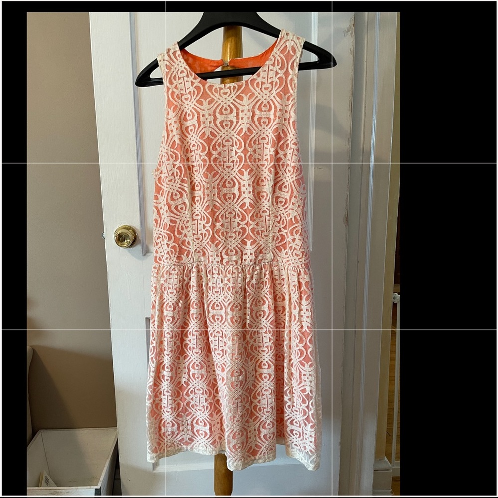 Sundress in tangerine with white lace.